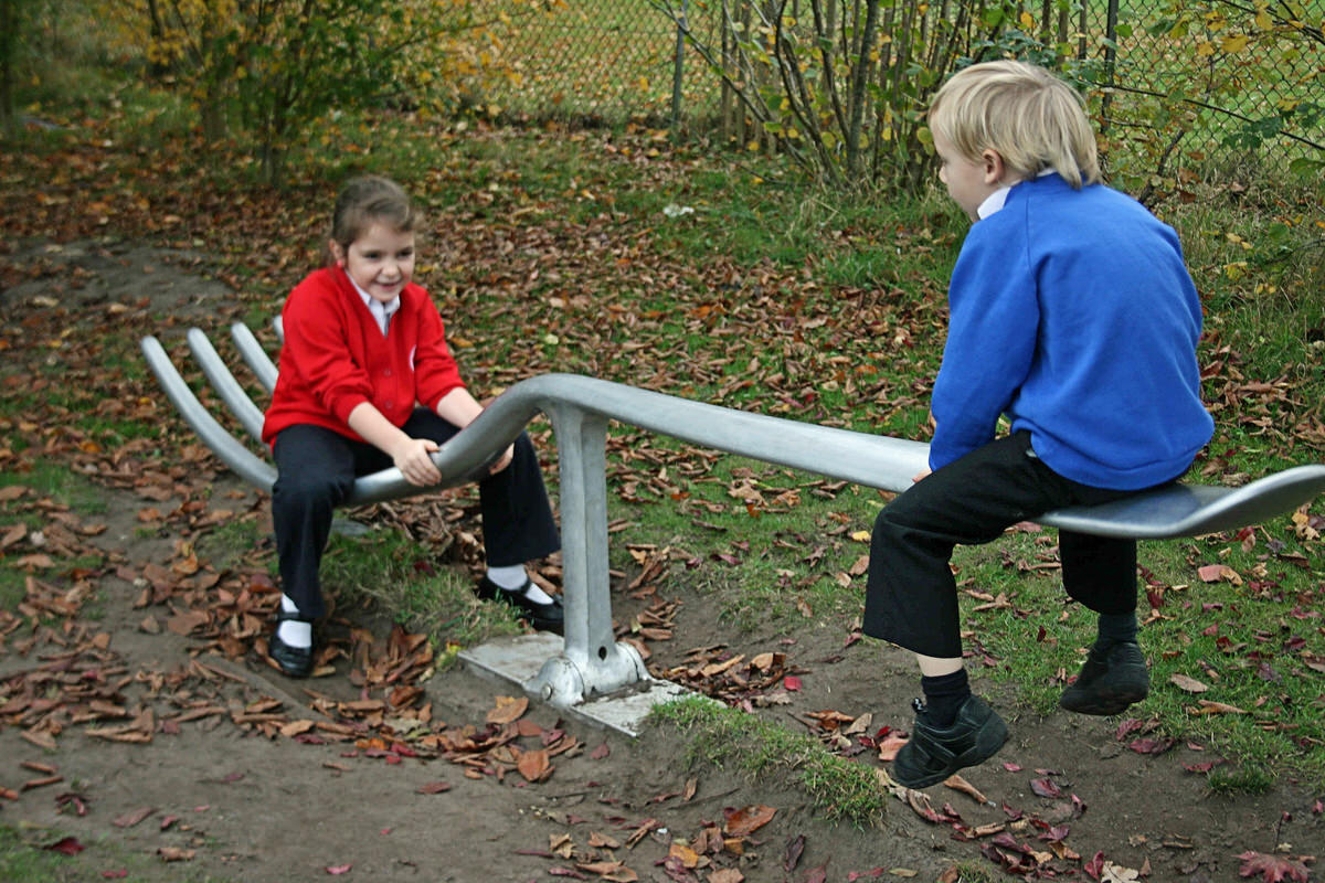Fork seesaw bespoke recycled alumininum sculpture primary elementary school by British artist sculptor Mark Reed unique garden play apparatus