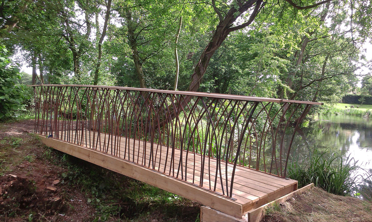 Prince's Trust Bridge bespoke metal bridge for gardens in garden by Mark Reed