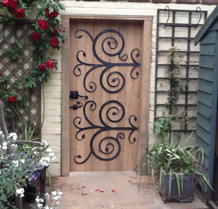 swirly door forged steel and french oak bespoke unique commission garden furniture door by Mark Reed
